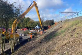 Engineers work on the unstable embankment that is under the track near Braybrooke