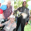 Madge Loake with husband Peter and Lewis Hamilton cut-out
