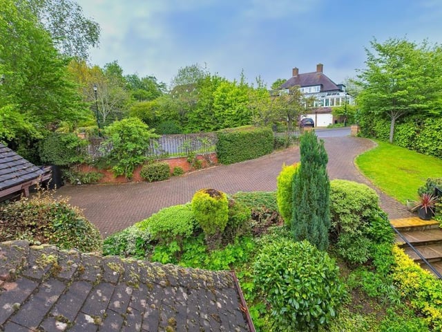 The large winding driveway seen from one of the property's upstairs bedroom windows