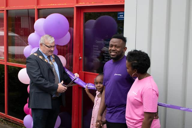 Mayor of Wellingborough, Cllr Jonathan Ekins cuts the ribbon with Solomon Soyinka, Yetunde Adebayo and their daughter