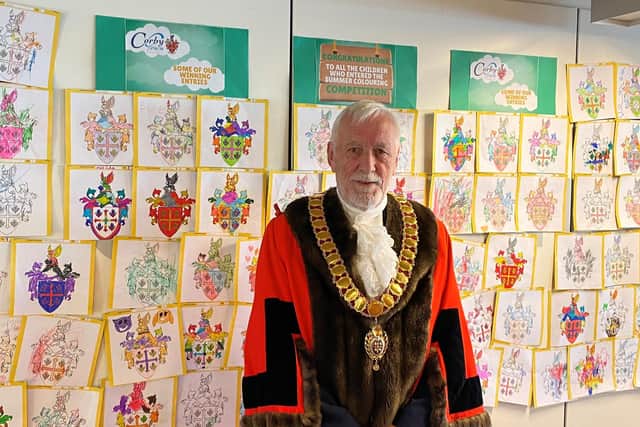 Corby mayor, Cllr Willie Colquhoun in front of the competition entries