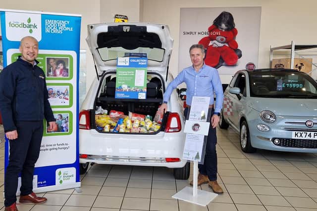 Pictured are Alec Pun (left) and Matthew Hall of Rockingham Cars with some of the donations received for Corby Foodbank