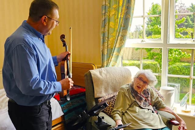 103-year-old resident Doris enjoying her unique room concert.