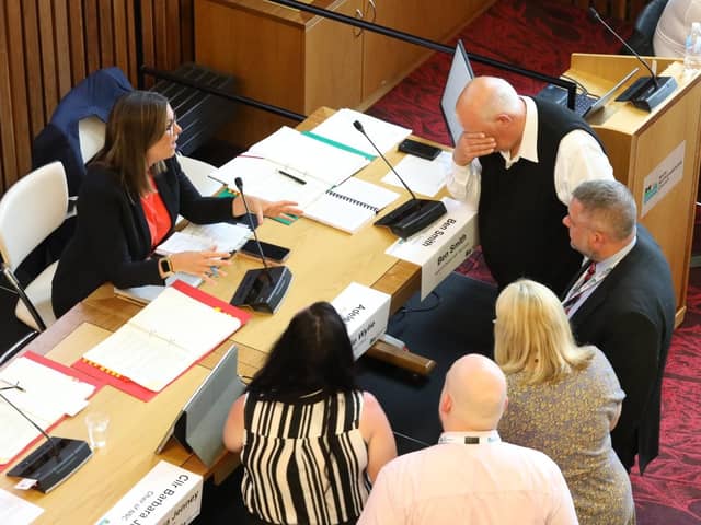 Cllr Jim Hakewill, head in his hand, after a pause in proceedings of the North Northants Council meeting to discuss the future of  Kettering Leisure Village as leaders meet with Adele Wylie (executive director of customer and governance)