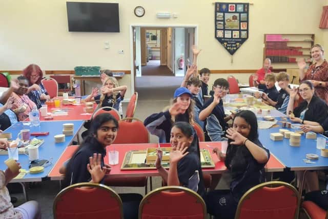 Students and crafters work together to decorate a mirror for the church