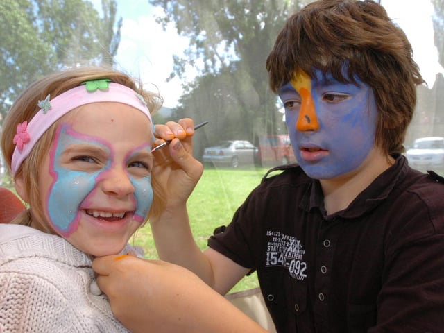 Corby Highland Gathering 2009: Harry Tomkins, from Glendon Scout and Guide Band, paints Isla McHugh's face