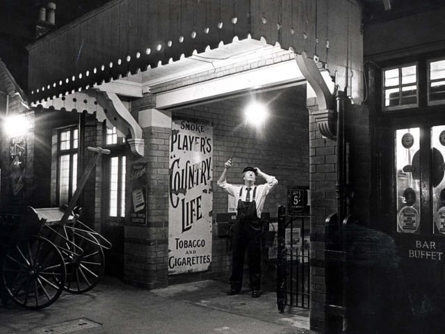 Richard Ashby lights the restored gas lighting at Rushden train station in November 1991
