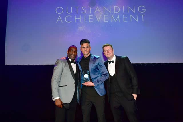 Dean (pictured centre) collecting his award from Derek Redmond (left) and Chris Webb (right).