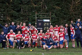 The Wellingborough players and staff celebrate after they clinched the title with a win at Bourne. Pictures by Shaun Davis