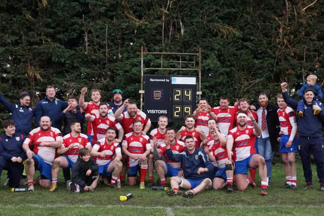The Wellingborough players and staff celebrate after they clinched the title with a win at Bourne. Pictures by Shaun Davis