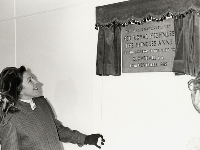 Princess Anne unveils a commemorative plaque during a visit to the Gloverall factory in Wellingborough in 1986