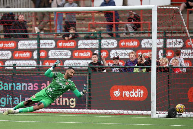 Jason Alexander can only watch as Redditch make it 4-0 from the penalty spot (Picture: Peter Short)