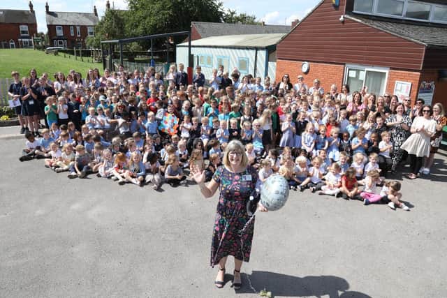 Linda Ward headteacher of Higham Infant and Nursery School with pupils and staff