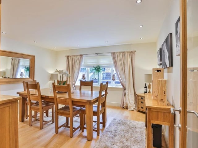 This modern family home is in a picturesque village and shares its boundary with a church.