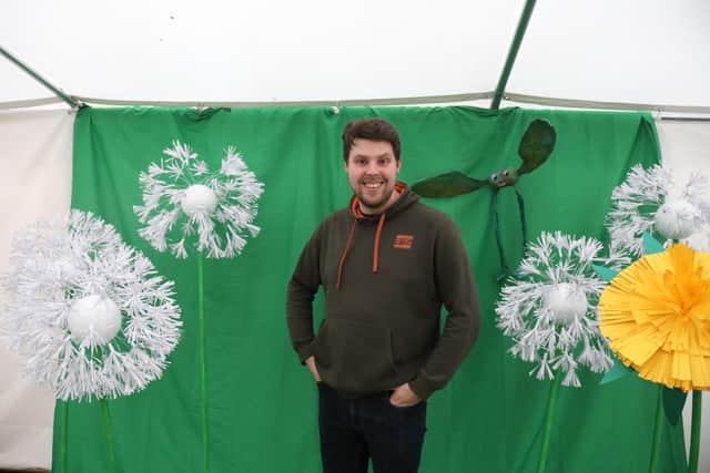 Henry Harwood with the huge paper flowers