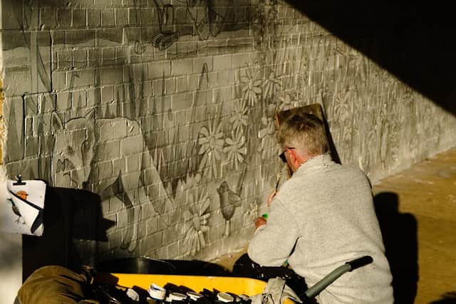 Rob Turner gets to work on the Embankment mural