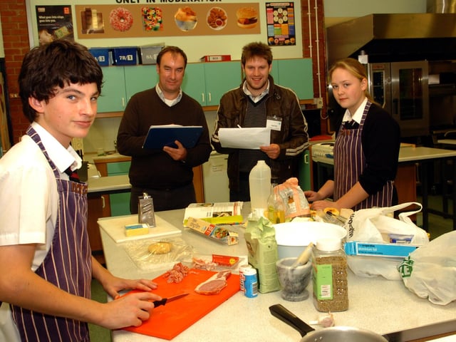 A November 2010 Rotary club cooking competition - David Farr and Megan Mould prepare the ingredients watched by judges Andy MacLeavy and Ian Campbell