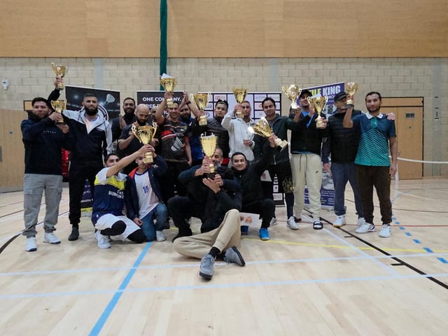 Players and organisers celebrating together at the Hatters Badminton Tournament 2025 following a successful event.