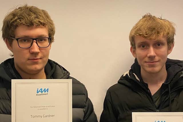 Tommy and Scott Gardner show off their new certificates