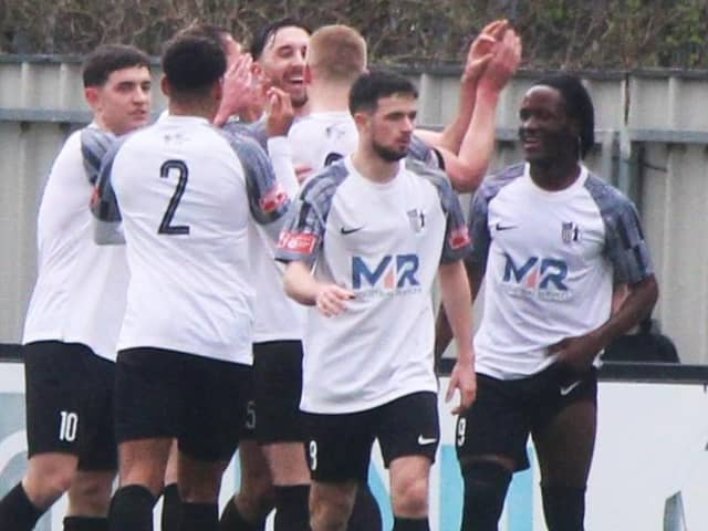 Charley Sanders takes the congratulations after scoring one of his two goals as he helped Corby Town beat Sutton Coldfield Town 3-1 on his debut for the club. Picture by David Tilley