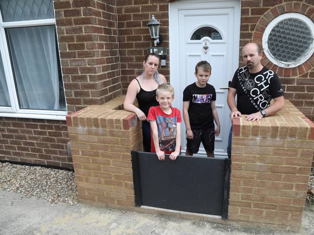 The Smith family with their flood defences to stop flooding at the front of their home in Hazel Road
Mum Michelle, Ashton, 9, Wyatt, 12, and dad Barry Smith