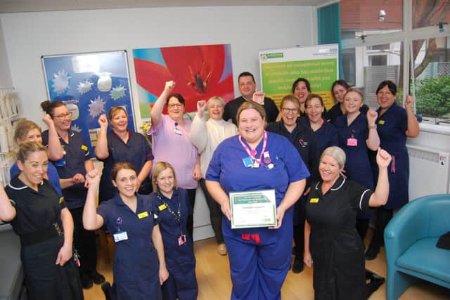 Midwife Hannah Crockatt with her award cheered by the midwifery team