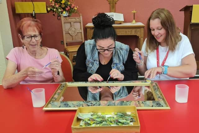 Jenny, Suzanne and Caroline start the decorating of the donated mirror