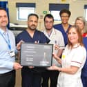 Jon Holton from Boston Scientific presents Principal Cardiac Physiologist Leanne Kelly, and the cardiac team, with a certificate to mark the achievement