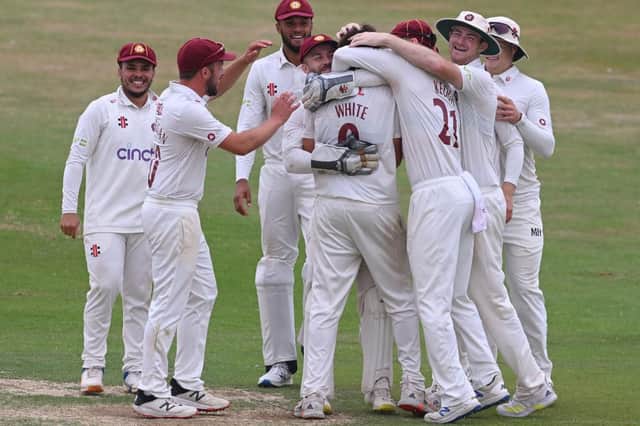Northants pace bowler Jack White is mobbed by his team-mates after claiming a first career five-wicket haul against Lancashire