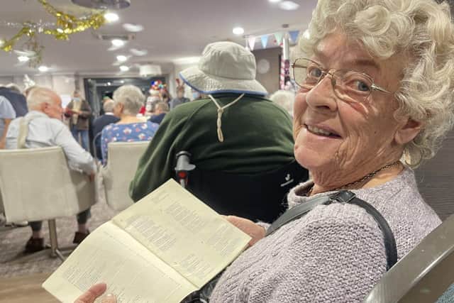 A resident enjoying the carol service