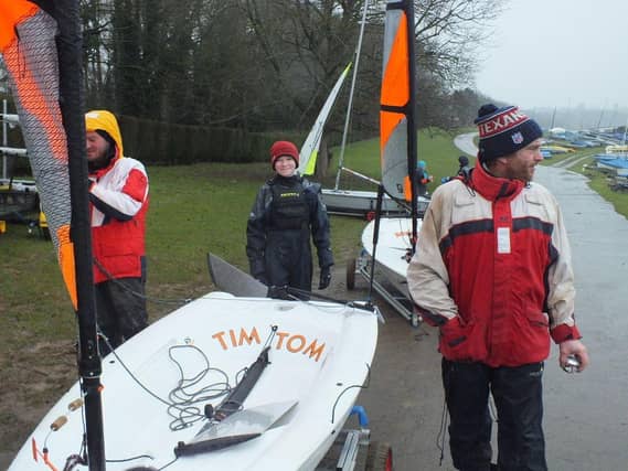 MNSC Head Coach Mark Greer (right) and his team colleague Roo Jarvis are helping a young sailor to get his boat ready.