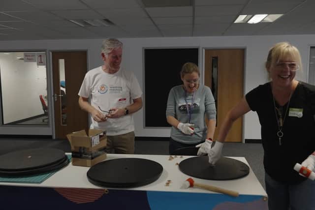 RS employees assemble washing machine components