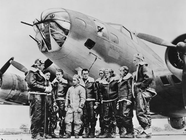 Captain William "Bill Musselwhite (far left) briefs the crew of Peggy Don, a Boeing B-17E Flying Fortress four engined bomber from the 342nd Bombardment Squadron, 97th Bomb Group of the United States Army Air Forces Eighth Air Force before the first Eighth Air Force heavy bomber mission of the war, attacking the Rouen-Sotteville marshalling yards in Nazi German occupied France on 17th August 1942 at RAF Grafton Underwood near Kettering, Northamptonshire, England.  (Photo by Three Lions/Hulton Archive/Getty Images).
