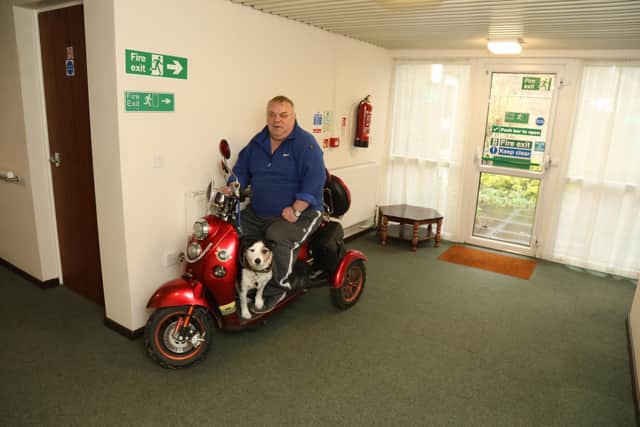 Robert Houston on his mobility trike, with dog Patch, where he has been parking it