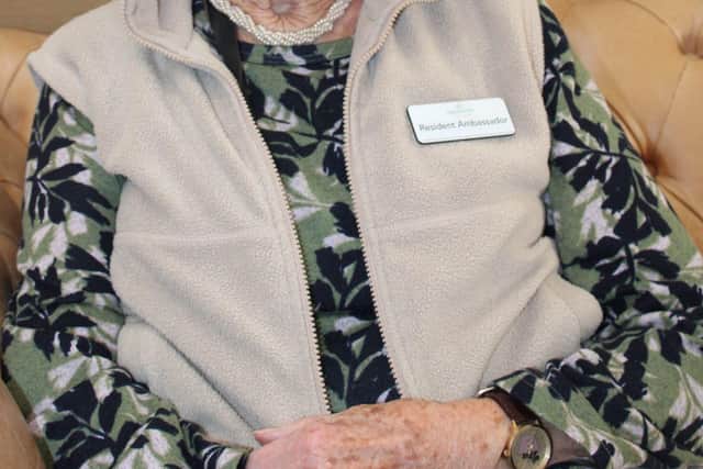 Janet sits proudly with her Barchester Resident Ambassador name badge