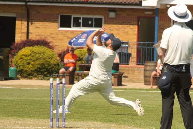 Sam Kumar steadies himself to take a catch during Rushden & Higham's win against Thrapston in Division One