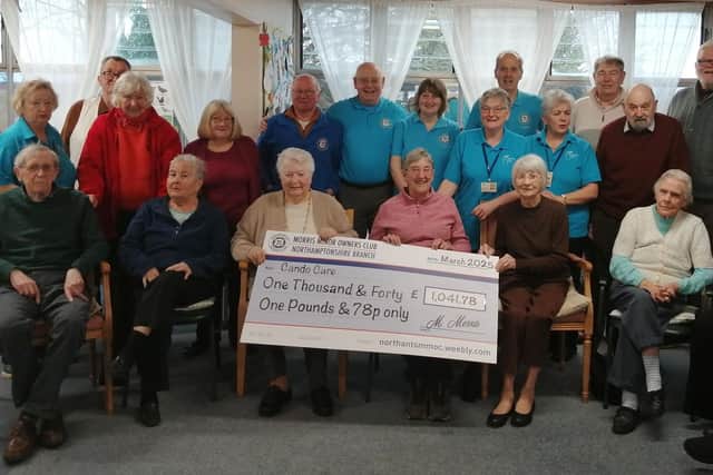 Members of the Northants Morris Minor club with staff volunteers and service users with the cheque.