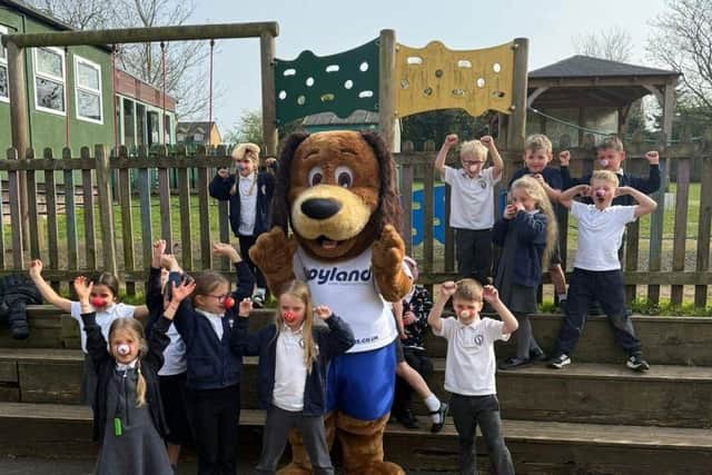 Croyland mascot Cooper the dog with pupils.
