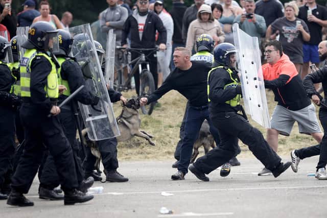 ROTHERHAM, ENGLAND - AUGUST 4: Riot Police clash with anti-migration protesters outside of the Holiday Inn Express in Manvers, which is being used as an asylum hotel, on August 4, 2024 in Rotherham, United Kingdom. Yesterday saw widespread violence as Far-right agitators in Liverpool and Manchester rioted and looted shops. Police were attacked and injured and dozens of arrests were made. (Photo by Christopher Furlong/Getty Images)