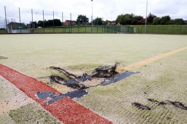 Parts of the uneven surface have torn and lifted up.