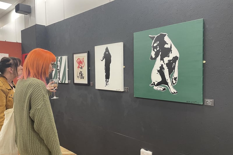 A visitor to Saturday night's preview checks out some Blek le Rat