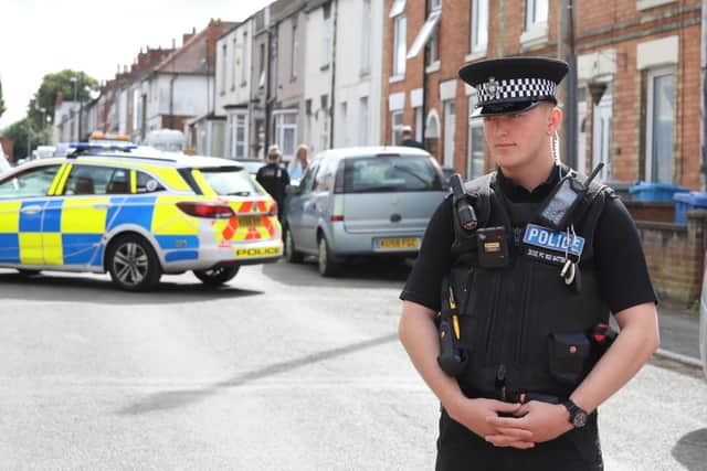 A police officer stands guard at the cordon in Buccleuch Street