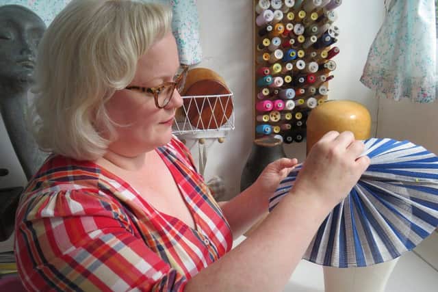 Sarah working in her millinery studio