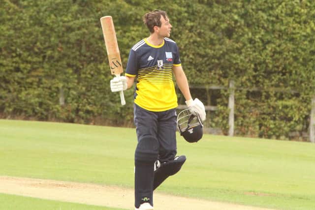 Callum Berrill holds his bat up after making a fine century in Finedon's win at Desborough