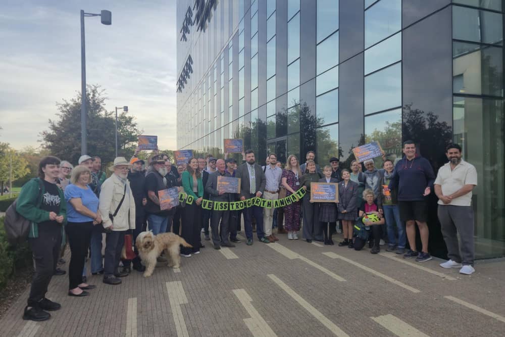 Protesters and councillors before the NNC meeting at the Corby Cube/IMG