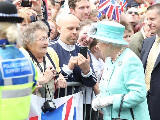 Her Majesty Elizabeth Queen II chats to a well-wisher in the crowd