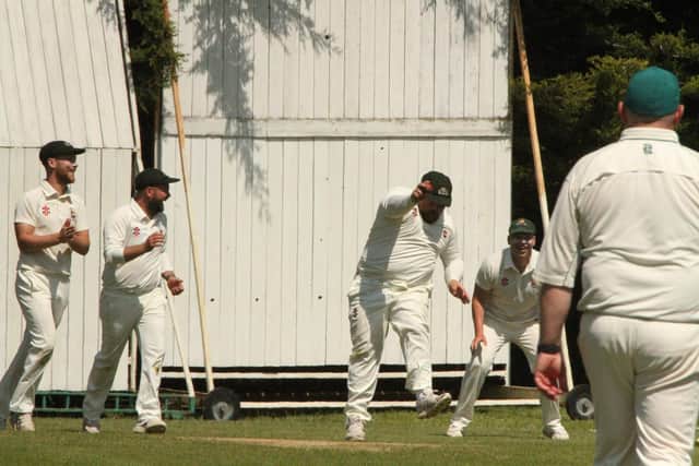 Thrapston celebrate capturing a Rushden & Higham wicket in their Division One clash