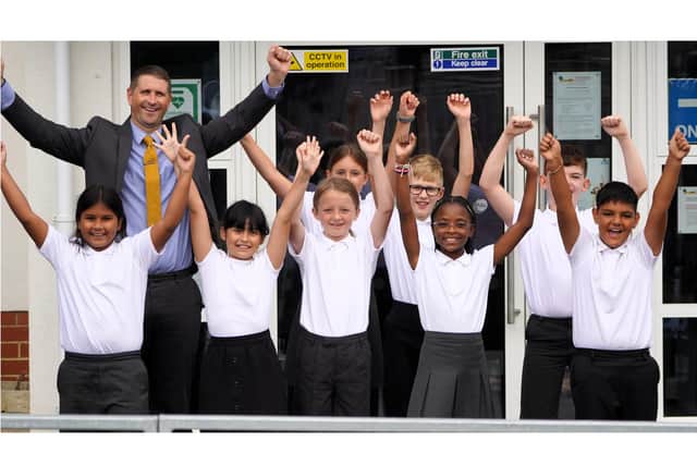 Head of Irchester Primary School Simon Anderson with pupils in celebratory mood
