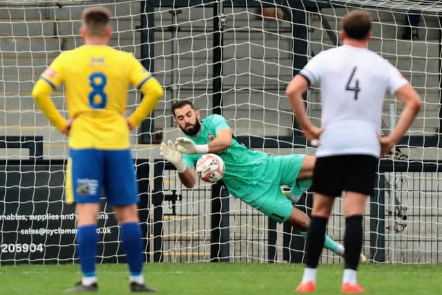 Dean Snedker saves Ryan Boothe's penalty, but the Corby striker netted on the rebound (Picture: Rob Webb)