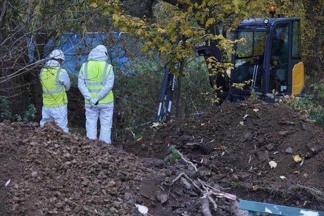 Forensic teams dig one of the anomalies.